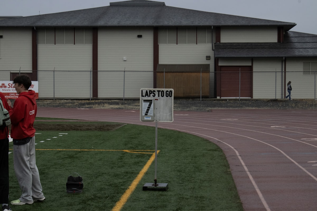 Adult Corgi happily running through an agility course with owner, showcasing the breed's athletic ca